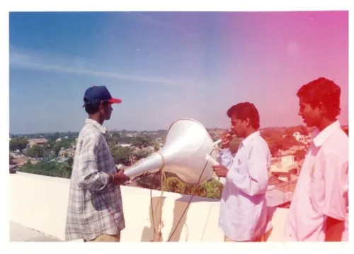 Volunteers using a loudspeaker for the polio awareness programme