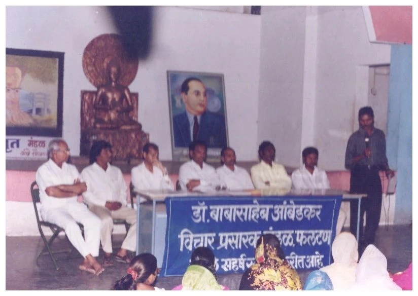 A community gathering with the Mandal’s banner, from the organisation’s archive
